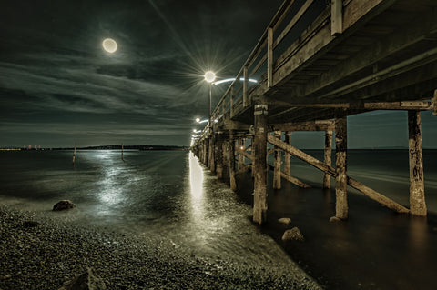 Pier Under Light Of Full Moon by Lone Tree Photography
