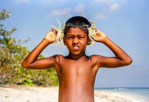 Boy With Crabs - Posters by Hassan Najmy