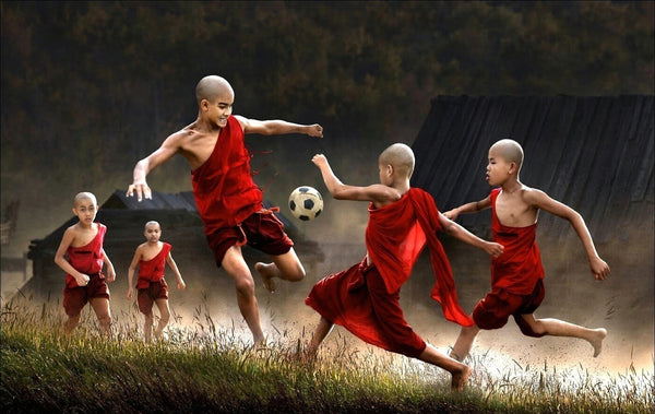 Young Monks Playing Football - Framed Prints